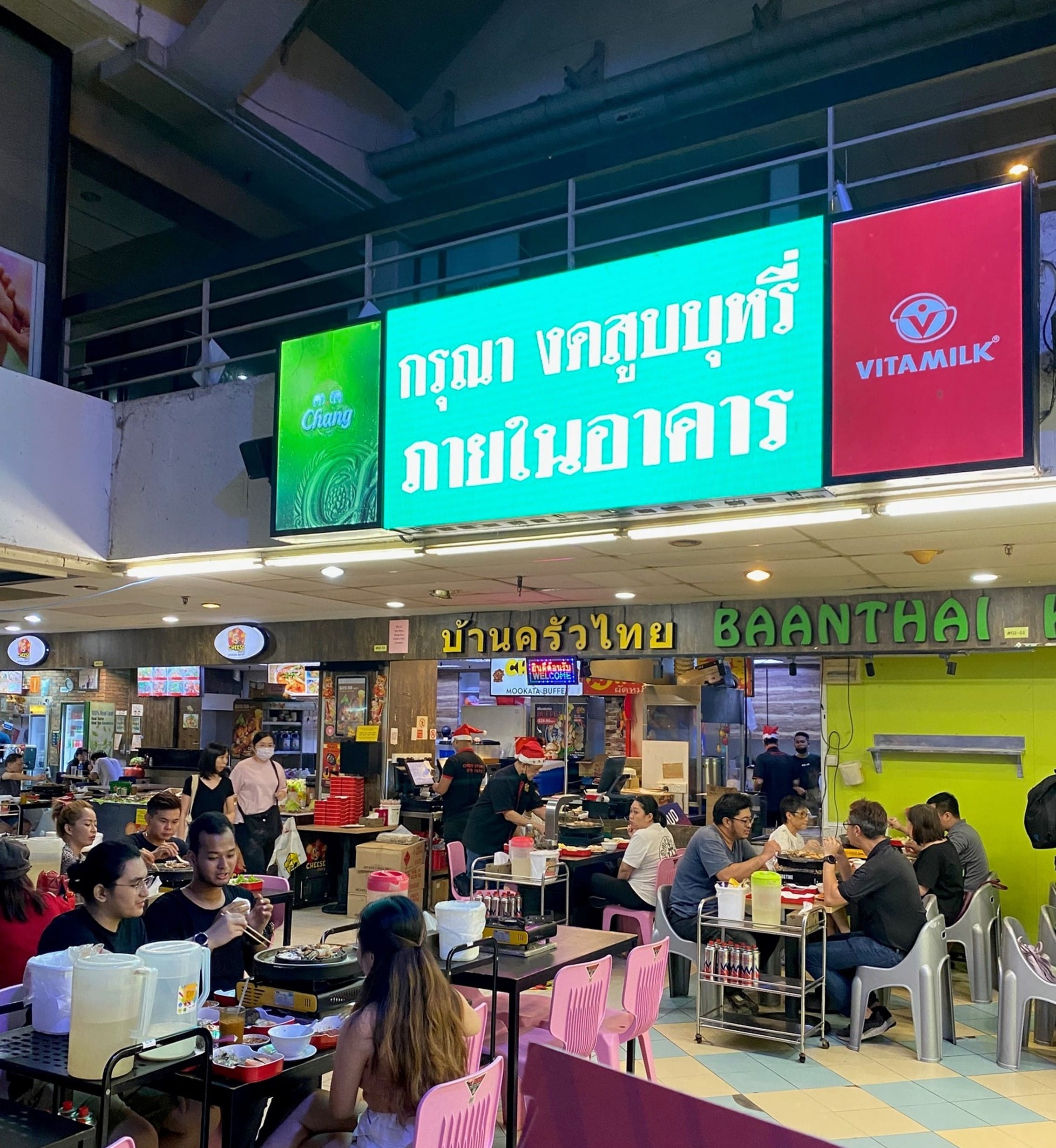 Ads in Thai above an eatery, 2022.